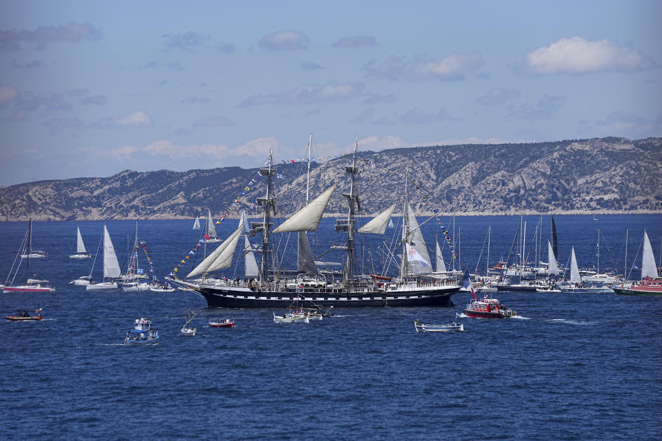 The Belem, the three-masted sailing ship bringing the Olympic flame from Greece, is escorted by other boats when approaching Marseille, southern France, Wednesday, May 8, 2024. After leaving Marseille, a vast relay route is undertaken before the torch odyssey ends on July 27 in Paris. The Paris 2024 Olympic Games will run from July 26 to Aug.11, 2024. (AP Photo/Laurent Cipriani)