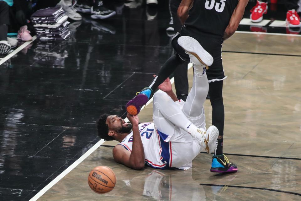 Game 3: The Philadelphia 76ers' Joel Embiid (21) falls to the floor after colliding with the Brooklyn Nets' Nic Claxton during the first quarter at Barclays Center on April 20.