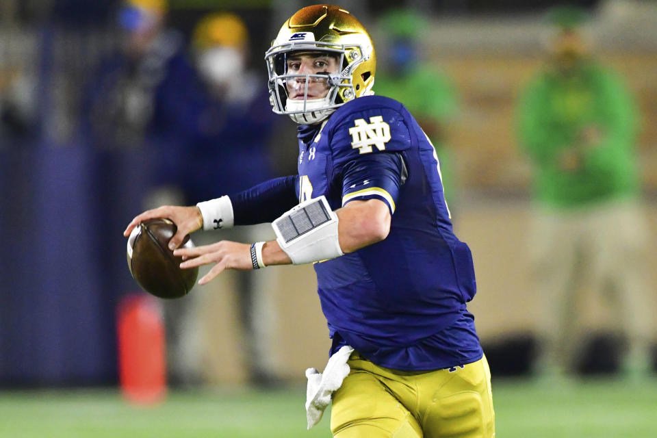 Notre Dame quarterback Ian Book looks for a receiver during the first quarter against Clemson in an NCAA college football game Saturday, Nov. 7, 2020, in South Bend, Ind. (Matt Cashore/Pool Photo via AP)