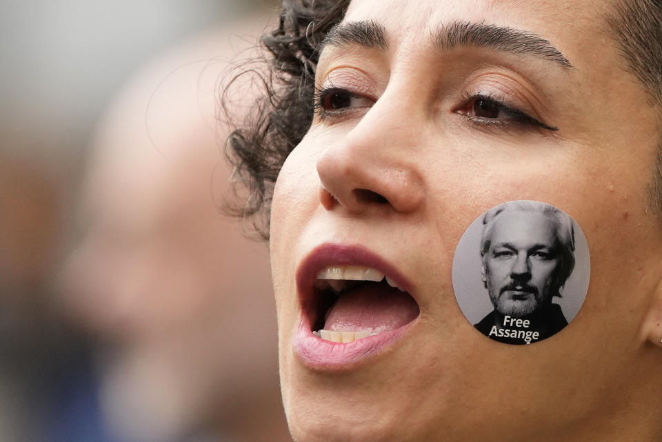 A protestor with a sticker on her cheek shouts as supporters stage a demonstration outside the High Court in London, Wednesday, Oct. 27, 2021. The U.S. government is scheduled to ask Britain's High Court to overturn a judge's decision that WikiLeaks founder Julian Assange should not be sent to the United States to face espionage charges. A lower court judge refused extradition in January on health grounds, saying Assange was likely to kill himself if held under harsh U.S. prison conditions. (AP Photo/Frank Augstein)