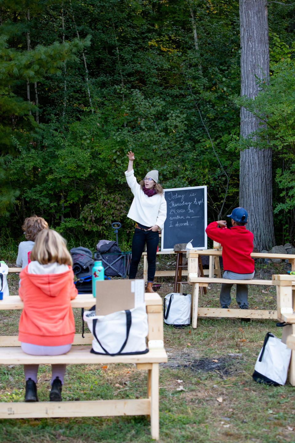 Bailey Johns instructs fourth graders in their outdoor classroom at Lake Champlain Waldorf School in Shelburne,fall 2021. The school incorporated more outdoor classroom learning during the COVID-19 pandemic, and saw a jump in enrollment afterward.