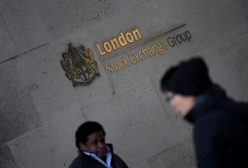 People walk past the London Stock Exchange Group offices in the City of London