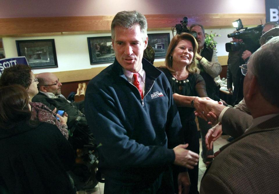 U.S. Sen. Scott Brown, R-Mass., center, and his wife Gail Huff, center right, greet people during a campaign event at a restaurant, in Milford, Mass., Thursday, Nov. 1, 2012. Brown and Democratic challenger Elizabeth Warren have already spent nearly $68 million pursuing the same U.S. Senate seat, shattering all previous spending records in Massachusetts. (AP Photo/Steven Senne)