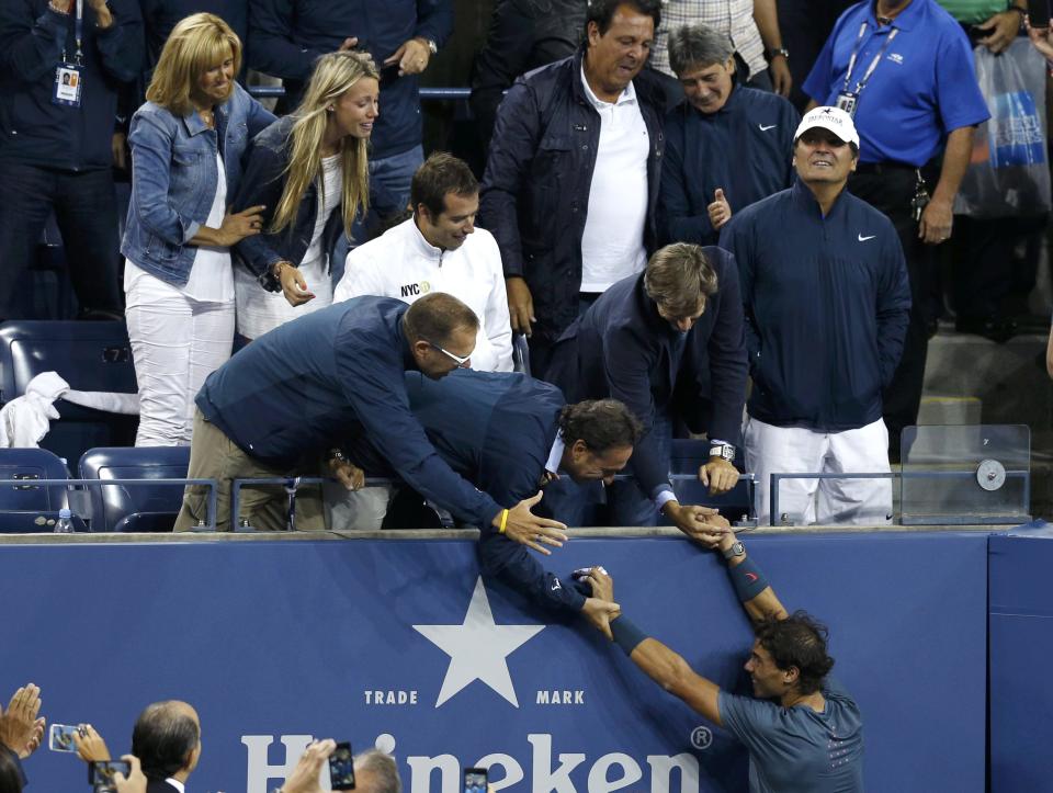 Nadal of Spain greets friends and family in the stands as he celebrates after defeating Djokovic of Serbia in their men's final match at the U.S. Open tennis championships in New York