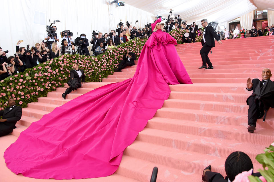 The singer-turned-actress’s 25-foot train was carried into the Met Gala by a group of suit-clad dancers [Photo: Getty]
