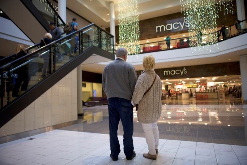 FILE PHOTO: Husband and wife, Jahan and Wendy Sampson hold hands by Macy's at the King of Prussia Mall, United States' largest retail shopping space, in King of Prussia, Pennsylvania