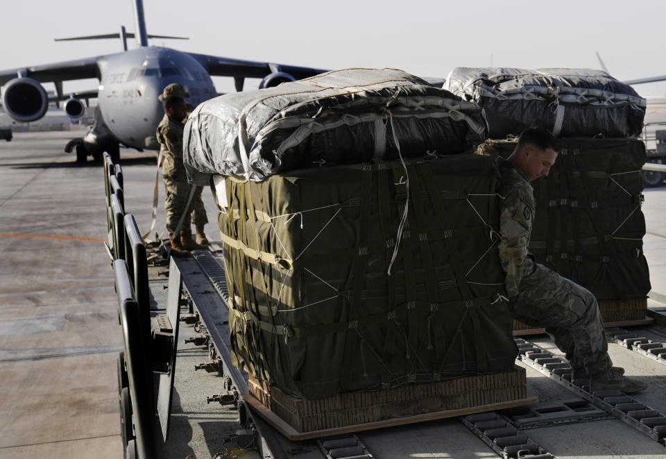 A member of the U.S. Air Force loads containers of humanitarian aid into an airplane at Al-Udeid Air Base, Qatar, Friday, March 29, 2024, prior to dropping them over the Gaza Strip. (AP Photo/Hussein Malla)