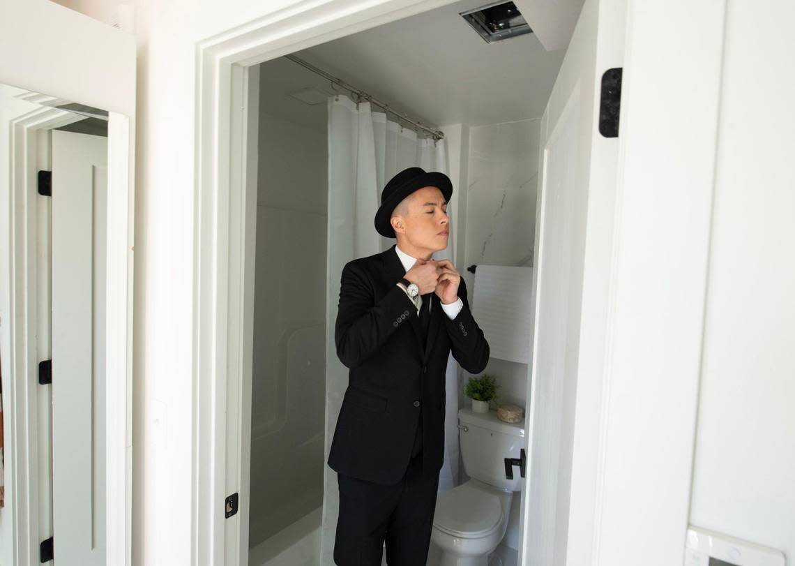 Paul Nagaoka, 38, a former model turned real estate developer, prepares for a photo shoot inside the model apartment just finished at the steel shipping container apartment complex at 31st and Summit streets.