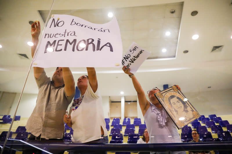 Human rights activist protests during a congress session against approving an amnesty bill that exempts the prosecution of crimes committed during the civil war, in San Salvador, El Salvador