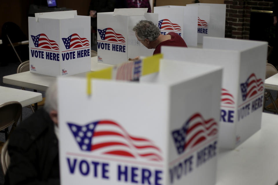 FILE - In this March 10, 2020, file photo, a man votes in the presidential primary election at the the Summit View Church of the Nazarene in Kansas City, Mo. Attorney General Derek Schmidt announced Tuesday, June 2, 2020, that he will appeal a 10th U.S. Circuit Court of Appeals decision in April that said the state could not enforce a proof-of-citizenship law. An appeals-court panel said the law violated the U.S. Constitution's guarantee of equal legal protection as well as a federal voter registration law. (AP Photo/Charlie Riedel, File)