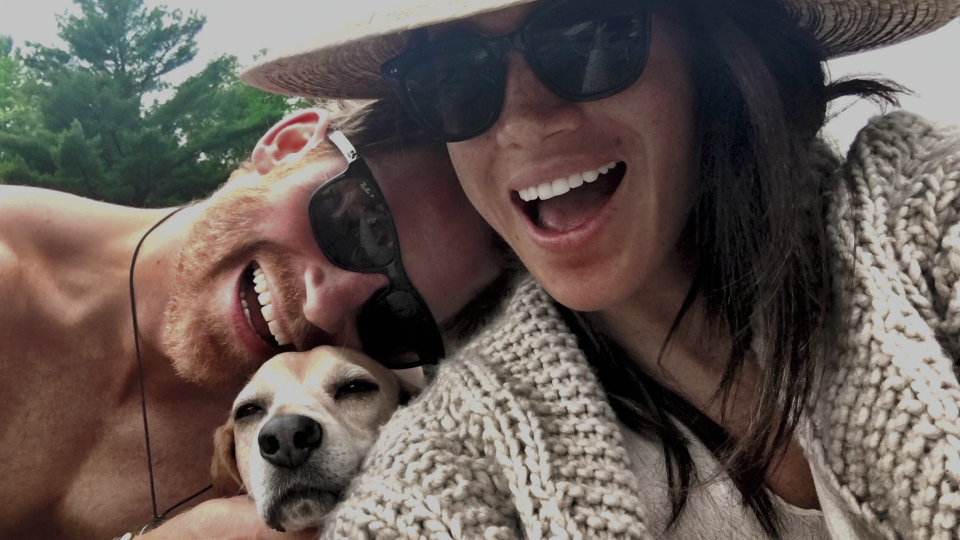 A selfie of Meghan Markle and Prince Harry with their dog between them. (Netflix)