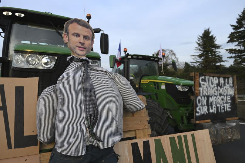 An effigy of French President Emmanuel Macron is seen on a tractor as farmers demonstrate on a highway, Monday, Jan. 29, 2024