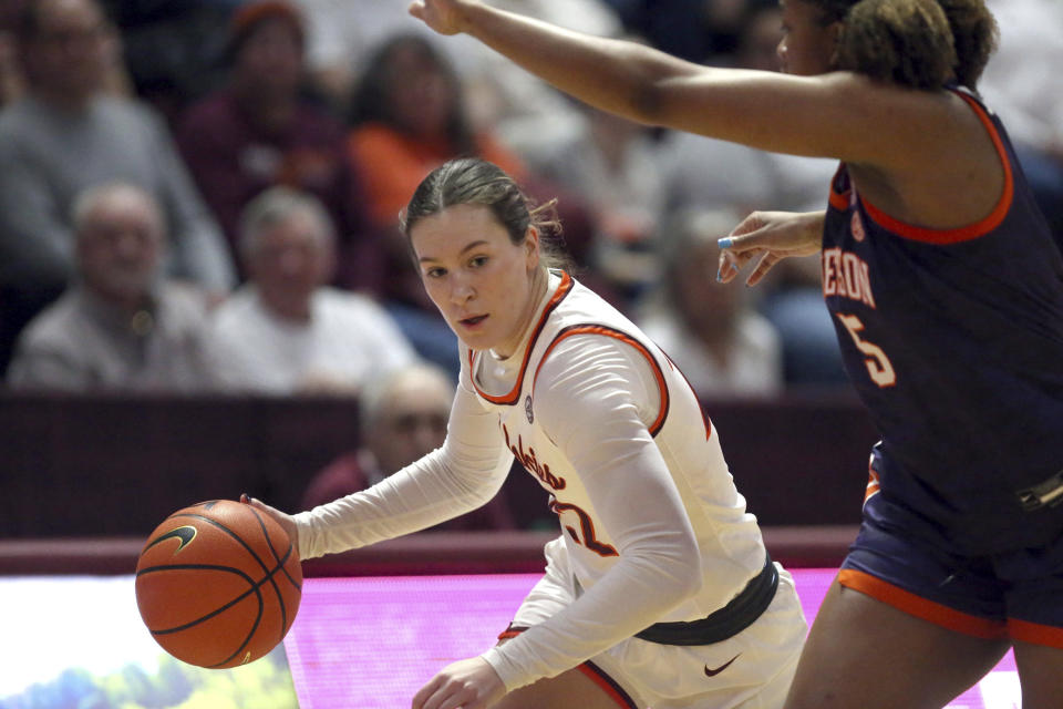 Virginia Tech's Cayla King (22) drives on Clemson's Amari Robinson (5) in the first half of an NCAA college basketball game in Blacksburg, Va, Sunday, Jan. 21, 2024. (Matt Gentry/The Roanoke Times via AP)