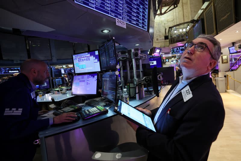 Traders work on the floor of the NYSE in New York