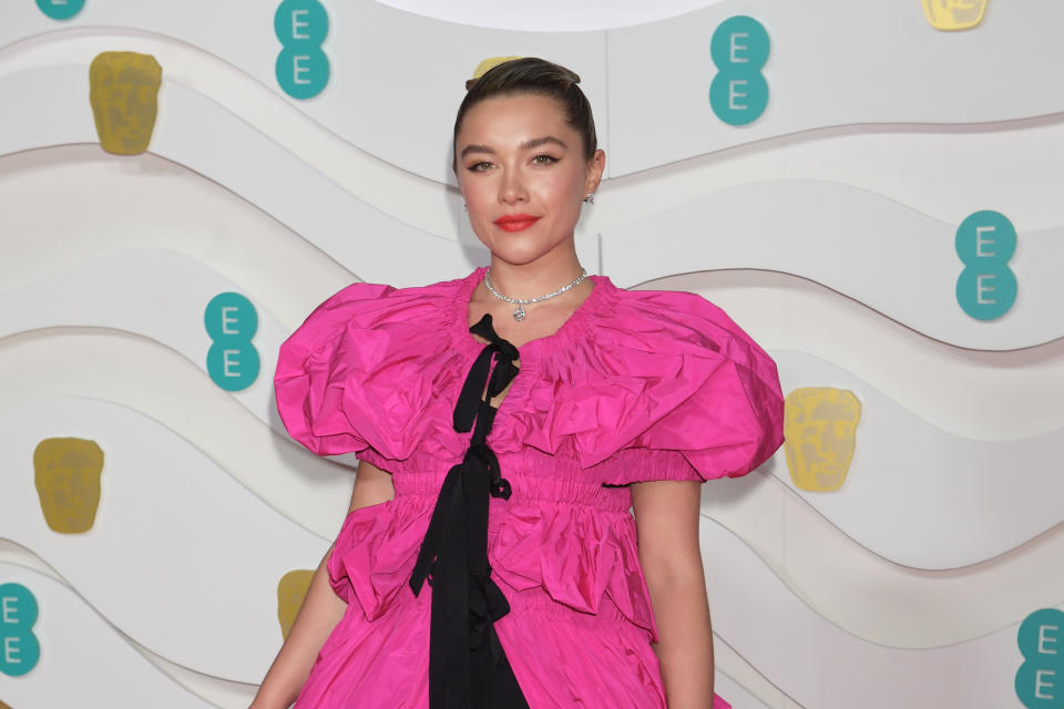 Florence Pugh laughed along in the audience. She was wearing a Dries Van Noten dress. [Photo: Getty]