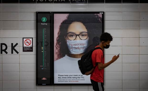 Transit riders walk on the platform at Victoria Park Station, in Toronto, on Aug. 24, 2021. (Evan Mitsui/CBC - image credit)