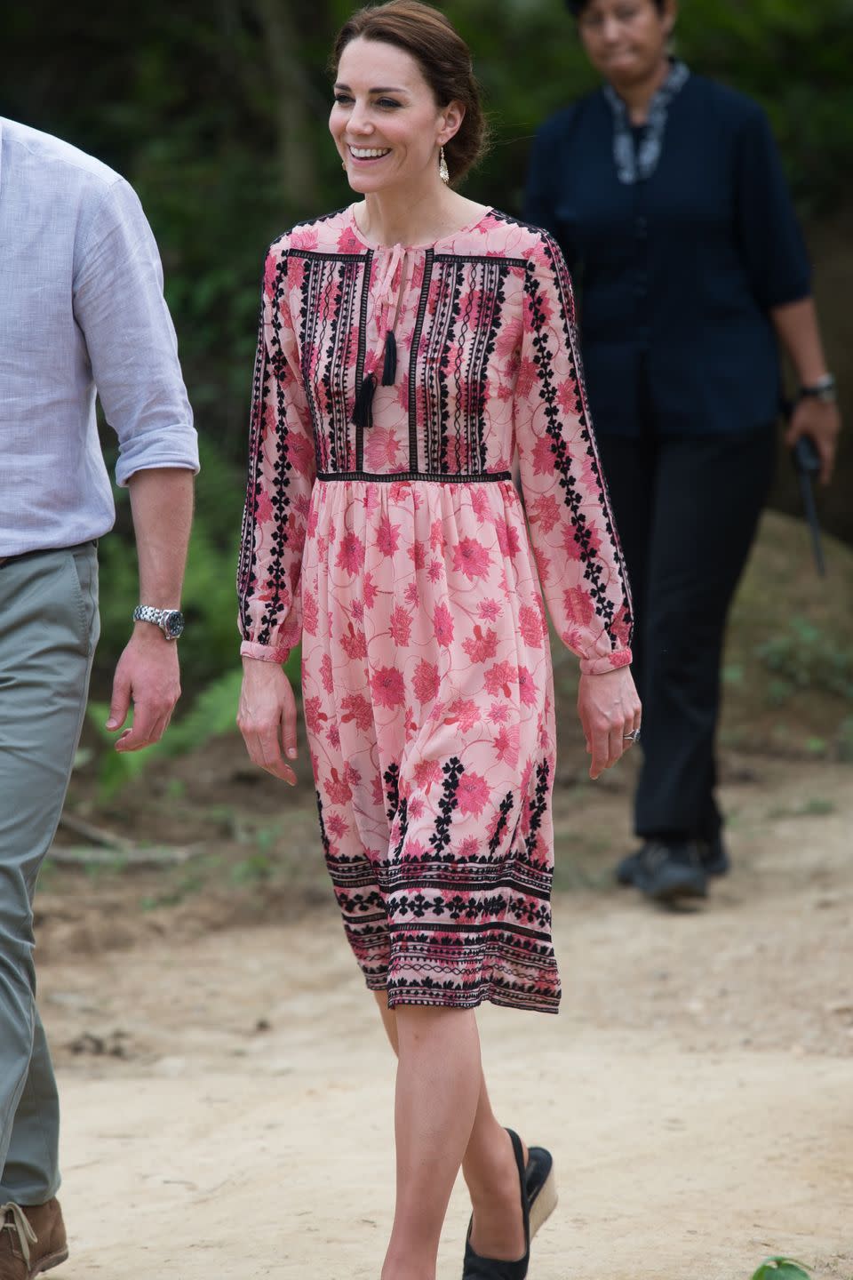 <p><em>April 13, 2016 — </em>Earlier on her trip to India and Bhutan, the Duchess chose a pink floral dress with black details from Topshop to visit to the Centre for Wildlife Rehabilitation and Conservation (CWRC) at Panbari reserve forest in Kaziranga to feed baby elephants.</p>