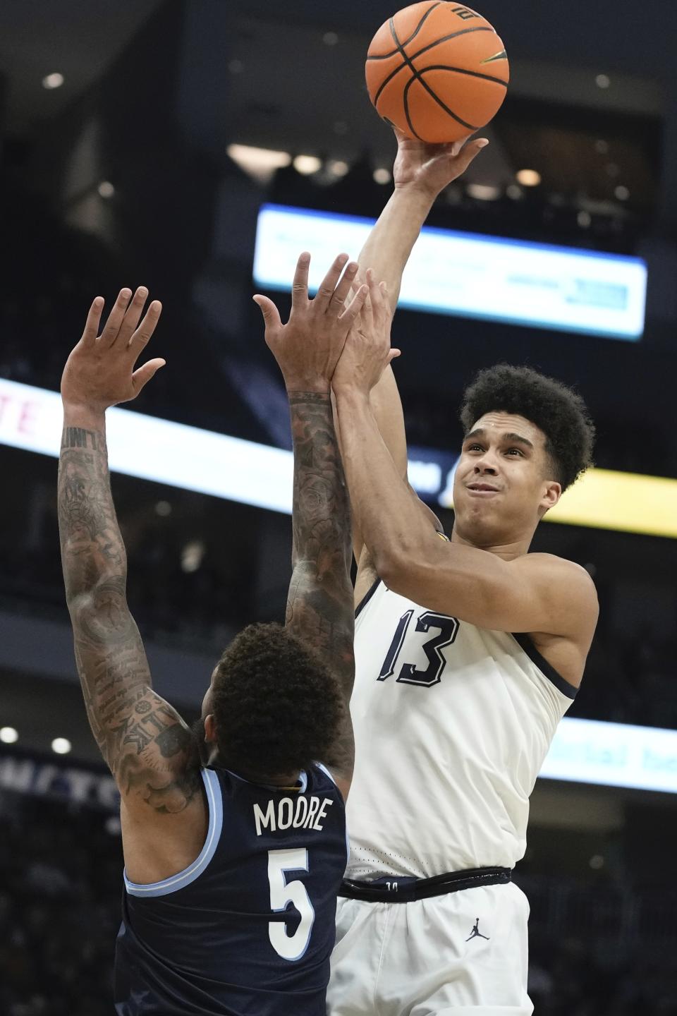 Marquette's Oso Ighodaro shoots over Villanova's Justin Moore during the first half of an NCAA college basketball game Wednesday, Feb. 1, 2023, in Milwaukee. (AP Photo/Morry Gash)