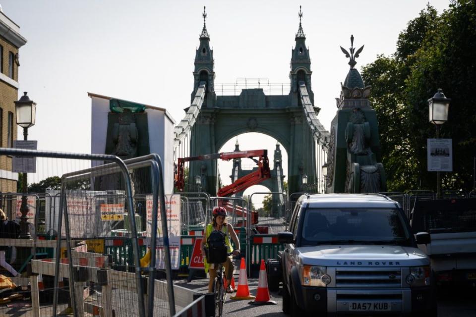 LONDON, ENGLAND - SEPTEMBER 17: A cyclist negotiates the closed paths and alleyways around Hammersmith Bridge which has now been closed for nearly a year and a half due to safety concerns, on September 17, 2020 in London, England. A number of London's bridges have recently either needed emergency repairs, or have been closed to the public entirely due to fears that they are structurally unsafe. In late August, Tower Bridge was closed for 48 hours after it suffered "technical issues" resulting in the iconic bridge remaining in the upright position, and Hammersmith Bridge has been closed to the public since April 2019 as it undergoes major structural repair. Elsewhere along the river, Vauxhall Bridge and London Bridge are closed to car traffic as urgent repair work takes place. Campaign groups have called for the repairs to be carried out in full and at speed, as roads and commutes become harder as people return to work after the COVID-19 lockdown. (Photo by Leon Neal/Getty Images)