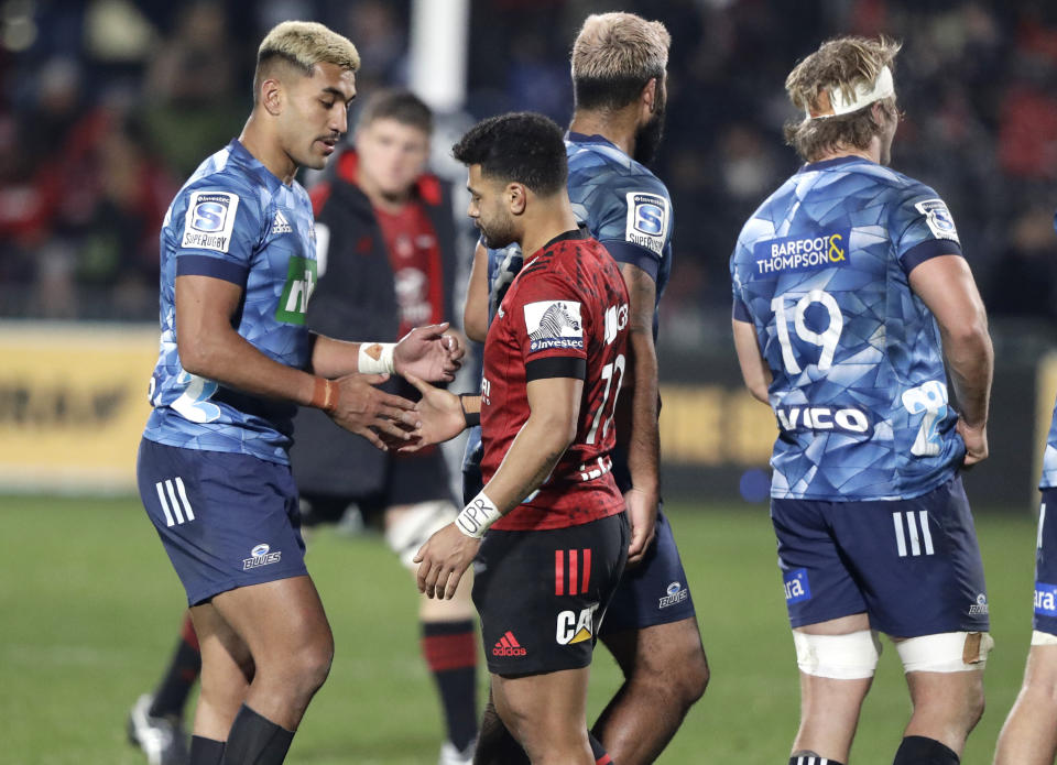 Blues Rieko Ioane, left, and Crusaders Richie Mo'unga shake hands following the Super Rugby Aotearoa rugby game between the Crusaders and the Blues in Christchurch, New Zealand, Saturday, July 11, 2020. (AP Photo/Mark Baker)