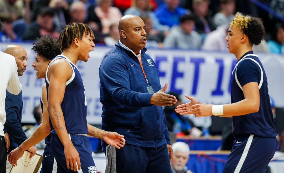 Warren Central head coach William Unseld reaches out to shake the hand of Warren Central guard Kade Unseld as the Dragons seal their win over Woodford County in the second half of Saturday's KHSAA Boys Sweet 16 semifinal. The Yellowjackets fell to the Dragons 56-48. March 18, 2023