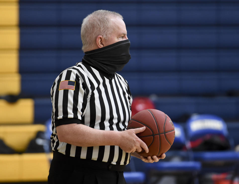 A Pennsylvania Interscholastic Athletic Association basketball official referees a game. (Ben Hasty/MediaNews Group/Reading Eagle via Getty Images)