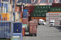 FILE - In this Oct. 2, 2019, file photo trucks hauling shipping containers line-up alongside containers stacked five-high to have them unloaded at a terminal on Harbor Island in Seattle. On Tuesday, Dec. 10, the Labor Department issues revised data on productivity in the third quarter. (AP Photo/Elaine Thompson, File)