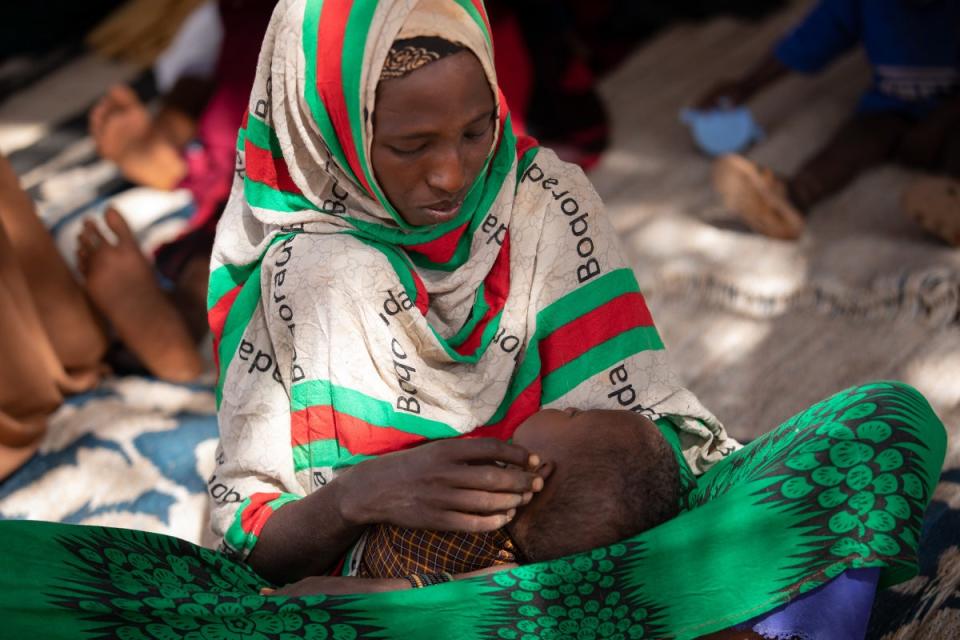 Mido holds her daughter Fatun in the waiting area of the clinic (WFP/Samantha Reinders)