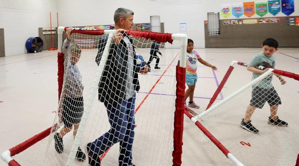 Third-grade math teacher Brian Horton puts away soccer goals after leading a gym class on Friday, April 14, 2023, at Houston Elementary in Mineral Wells. Mineral Wells ISD offers a catch-up day held on Fridays for students who signed up at the beginning of the year. The program offers a mix of academics and enrichment activities throughout the day and is available for students up to fourth grade.