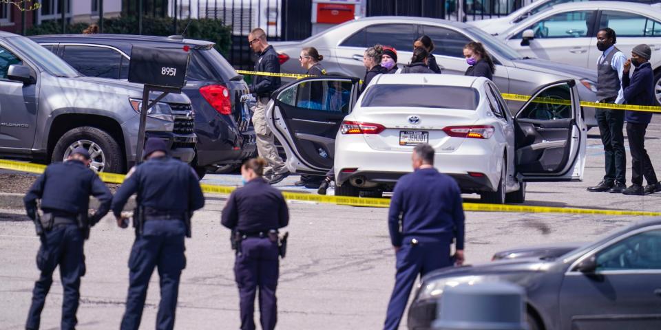 Law enforcement confer at the scene, Friday, April 16, 2021, in Indianapolis, where multiple people were shot at a FedEx Ground facility near the Indianapolis airport.