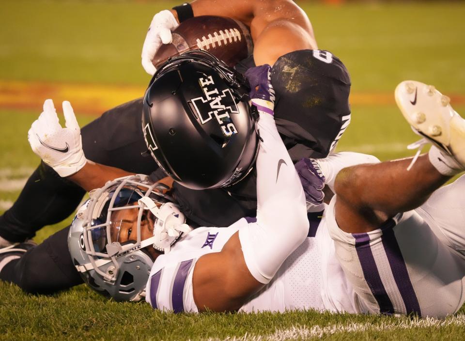 Iowa State wide receiver Xavier Hutchinson, top, is tackled by Kansas State safety Josh Hayes during Saturday's game in Ames.