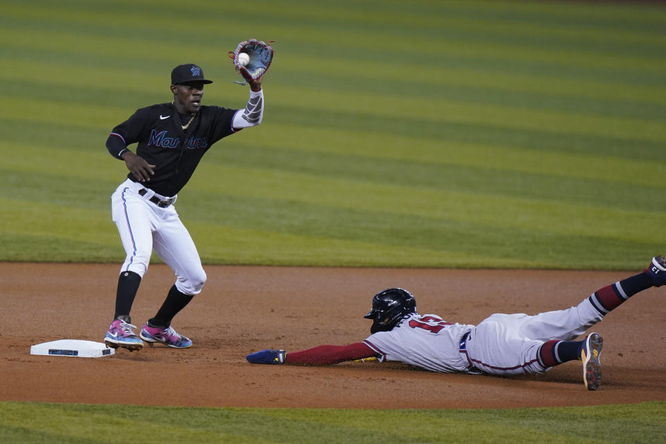 Atlanta Braves' Ronald Acuna Jr. (13) steals second base as Miami Marlins shortstop Jazz Chisholm Jr. catches the throw to attempt the tag during the first inning of a baseball game, Friday, June 11, 2021, in Miami. (AP Photo/Wilfredo Lee)