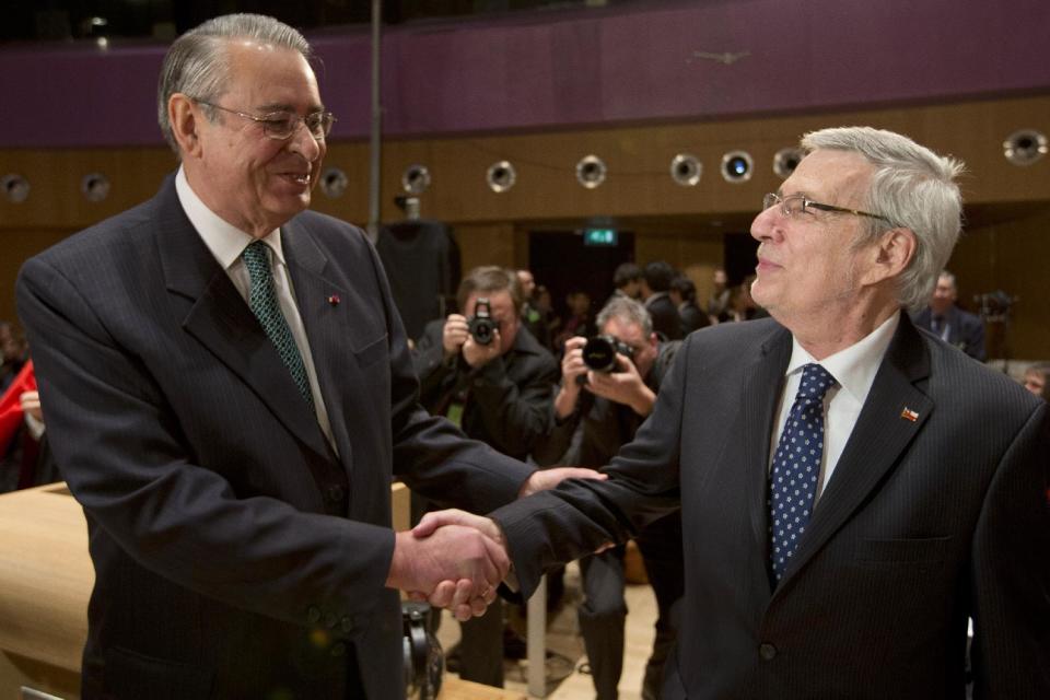 Peru's ambassador Allen Wagner, left, shakes hands with Chile's ambassador Albert van Klaveren Stork, right, prior to the start of hearings in a dispute between Peru and Chile over the two countries' maritime boundary at the International Court of Justice in The Hague, Monday Dec. 3, 2012. (AP Photo/Peter Dejong)