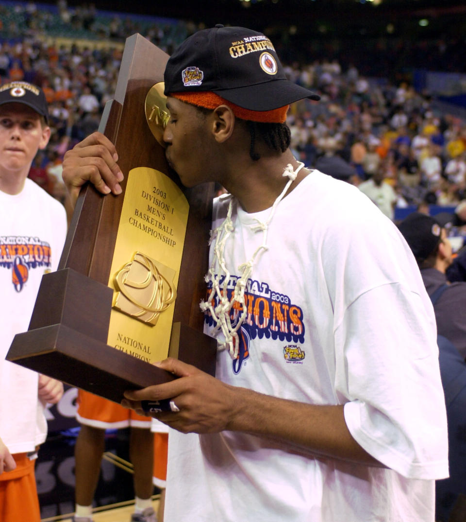 FILE - Syracuse's Carmelo Anthony kisses the trophy after winning the championship game 81-78 against Kansas at the NCAA college basketball Final Four in New Orleans, April 7, 2003. Anthony got better as Syracuse went deeper into the tournament, scoring 33 points in the Final Four against Texas and finished with 20 and 10 rebounds against Kansas for the Orange's first national title.(AP Photo/Ed Reinke, File)