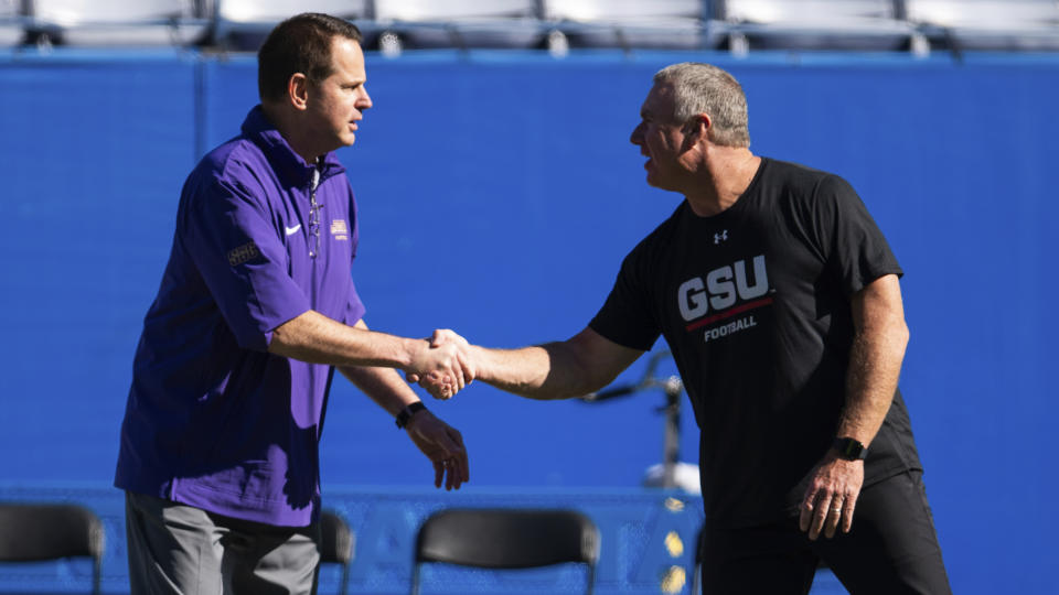 James Madison head coach Curt Cignetti, left, shake hands with Georgia State head coach Shawn Elliott, right, before an NCAA college football game Saturday, Nov. 4 2023, in Atlanta. (AP Photo/Hakim Wright Sr.)