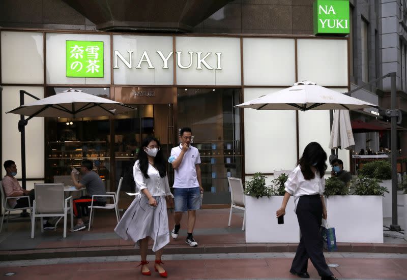 FILE PHOTO: Customers leave a store of Chinese bubble tea chain Nayuki in Beijing