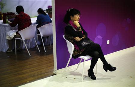 A woman sits during a matchmaking event for middle-aged singles and seniors, sponsored by Shanghai's government, in Shanghai November 9, 2013. REUTERS/Carlos Barria