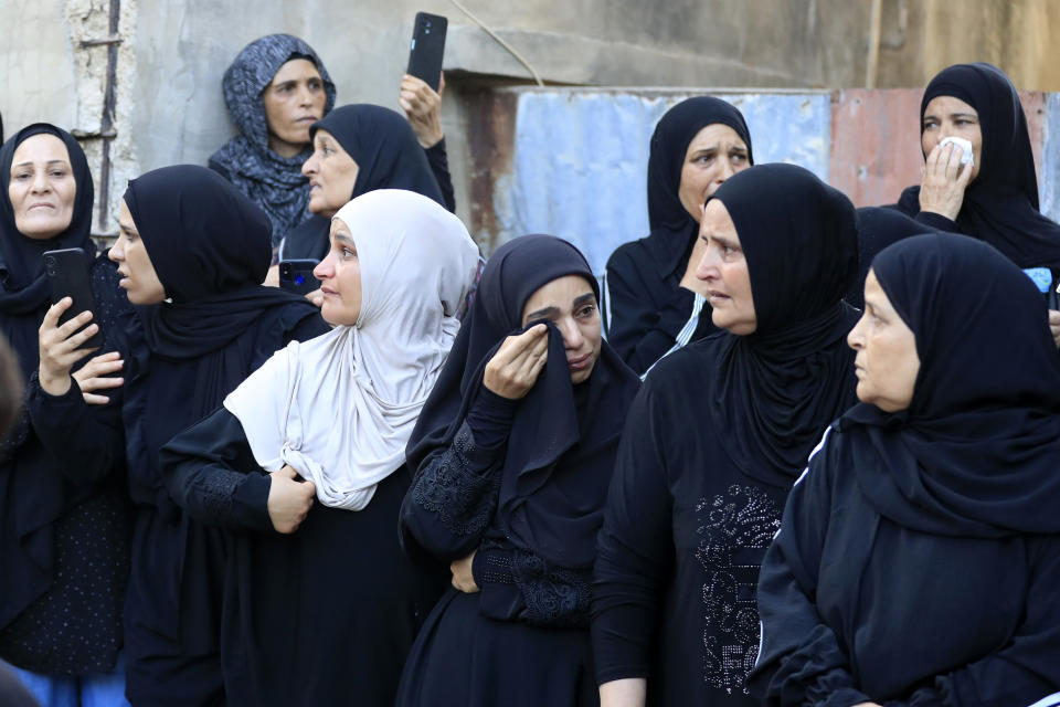 Palestinian women mourn during the funeral procession of Abu Ashraf al-Armoushi, the Palestinian National Security Commander in the Saida region, at Rashidiyeh Palestinian refugee camp, southern Lebanon, Monday, July 31, 2023. (AP Photo/Mohammad Zaatari)