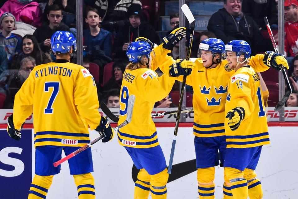 Team Sweden celebrates a goal at the world junior championships.