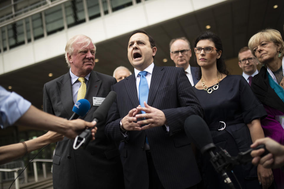 British lawmaker Alberto Costa, second left, along with a cross-party delegation of British parliamentarians talk to journalists after meeting European Union chief Brexit negotiator Michel Barnier at the European Commission headquarters in Brussels, Friday, July 19, 2019. (AP Photo/Francisco Seco)