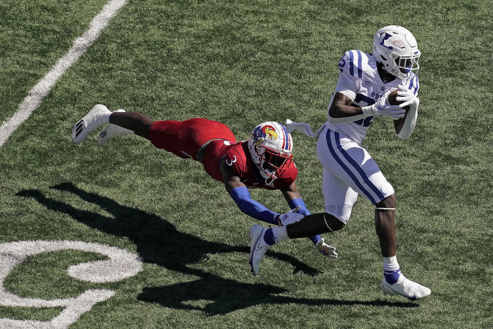 Duke running back Jaylen Coleman (22) is tackled by Kansas cornerback Ra'Mello Dotson (3) during the first half of an NCAA college football game Saturday, Sept. 24, 2022, in Lawrence, Kan. (AP Photo/Charlie Riedel)
