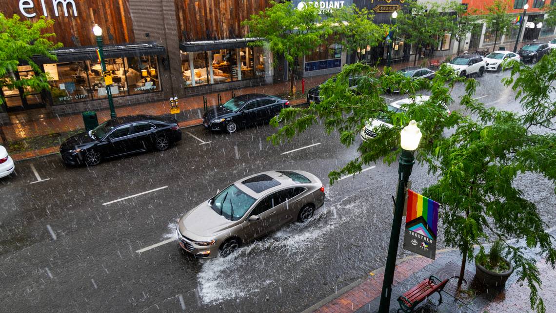 A vehicle splashes through a flooded area of downtown Boise during a flash thunderstorm earlier this year.