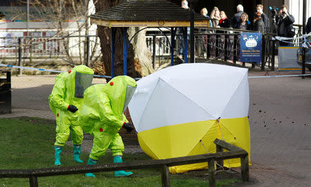 The forensic tent, covering the bench where Sergei Skripal and his daughter Yulia were found, is repositioned by officials in protective suits in the centre of Salisbury, Britain, March 8, 2018. REUTERS/Peter Nicholls