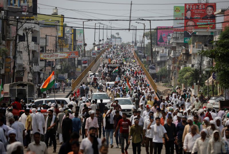 People arrive to attend a Maha Panchayat or grand village council meeting as part of a farmers' protest against farm laws in Muzaffarnagar