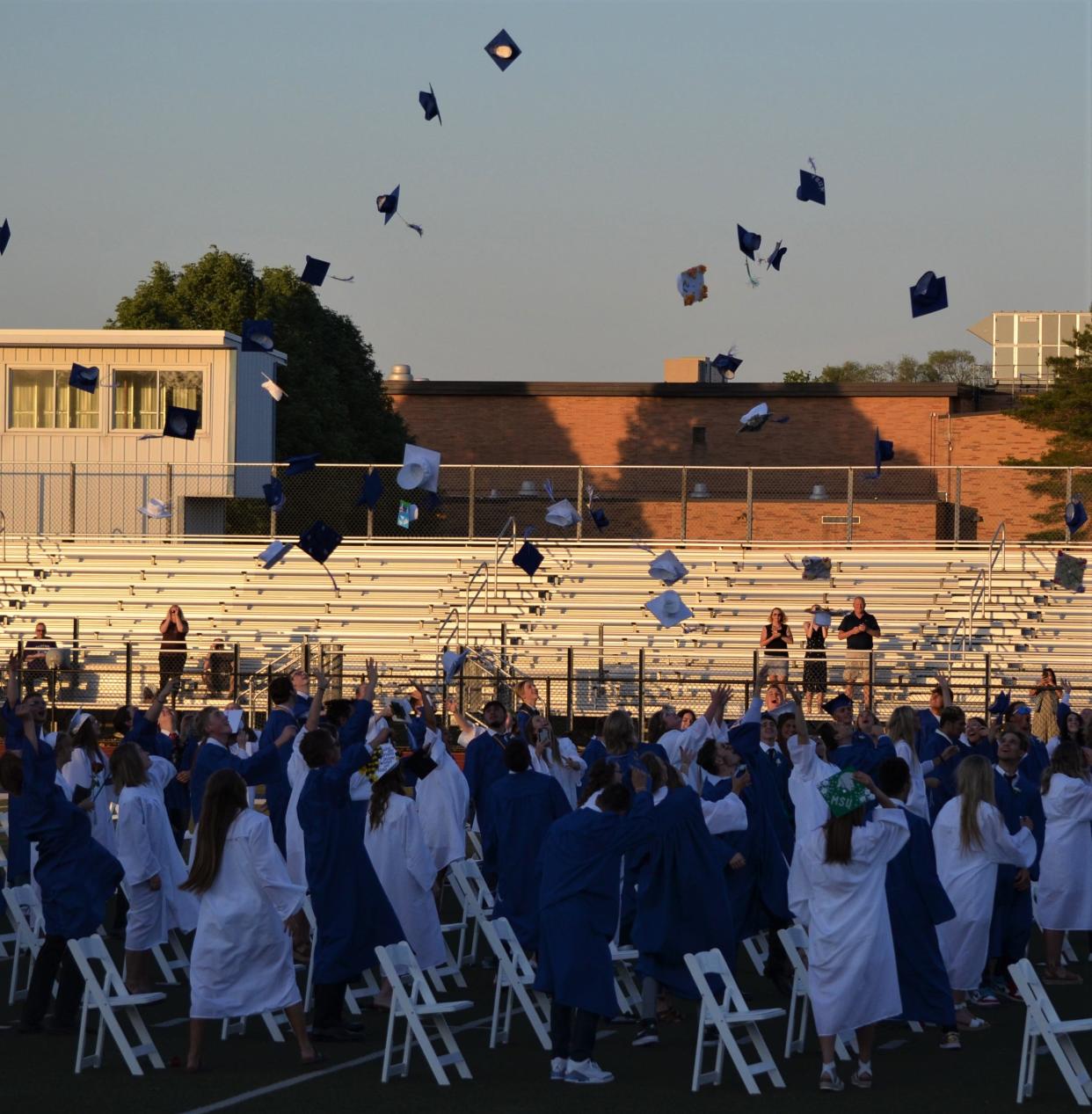 The Harper Creek Class of 2021 celebrates at the Harper Creek High School football field at graduation ceremonies on June 4, 2021.