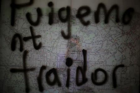 A graffiti reading "Puigdemont (Catalan President) traitor" is seen on a Barcelona's map at a bus stop in Barcelona, Spain, October 23, 2017. REUTERS/Ivan Alvarado