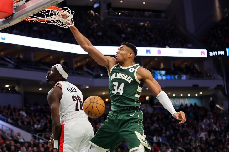 Giannis Antetokounmpo of the Milwaukee Bucks dunks over Duop Reath of the Portland Trail Blazers during the first half of a game at Fiserv Forum on Nov. 26, 2023.