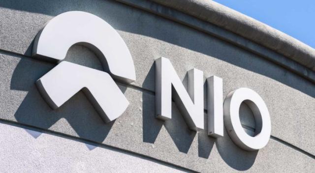 Image of Nio (NIO) logo branded on the exterior of a corporate building.