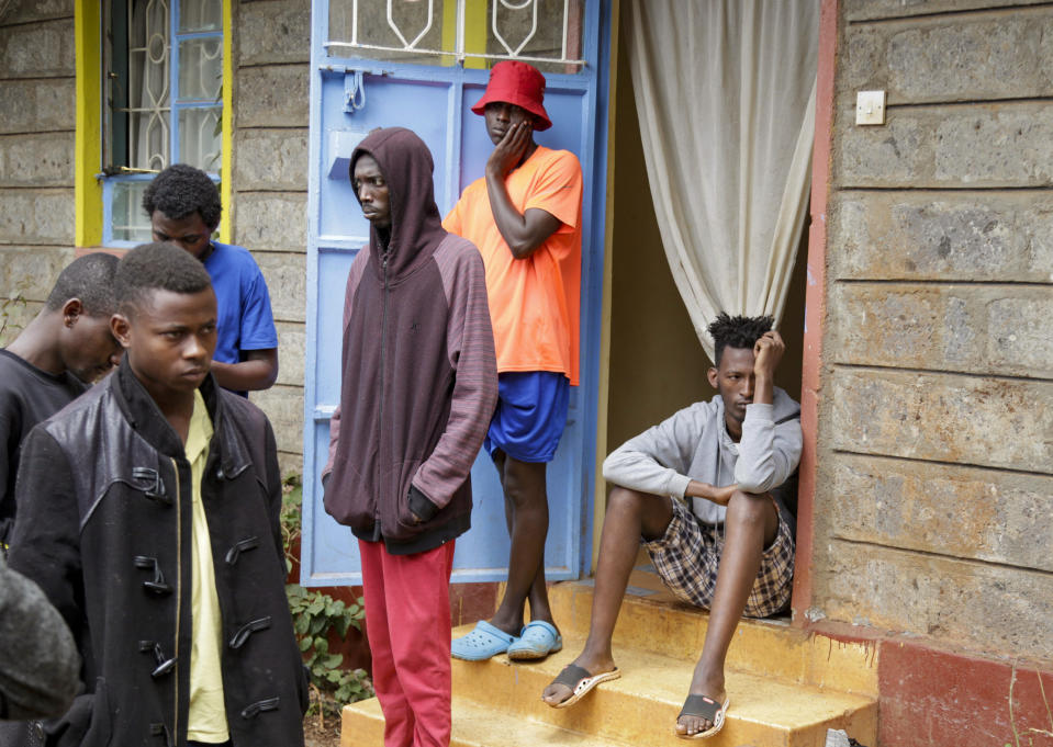 In this photo taken Tuesday, May 28, 2019, LGBT refugees stand outside the house where they take shelter in a low-income neighborhood of the capital Nairobi, Kenya. LGBT refugees allege they have been harassed by police in recent weeks in Kenya, which is a rare regional haven for the gay community yet maintains that gay sex is illegal. (AP Photo/Khalil Senosi)