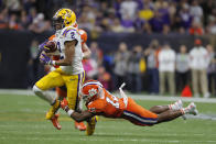 LSU wide receiver Justin Jefferson is tackled by Clemson safety K'Von Wallace during the second half of a NCAA College Football Playoff national championship game Monday, Jan. 13, 2020, in New Orleans. (AP Photo/Gerald Herbert)